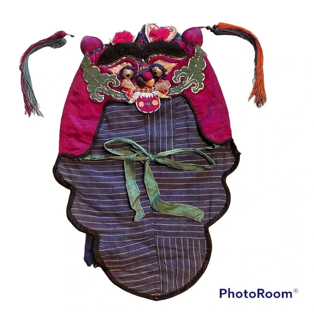 Antique vintage Asian child’s embroidered hat. Festival celebration festival